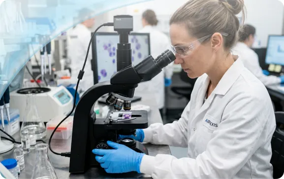 Scientist working at a microscope in the AirNexis laboratory